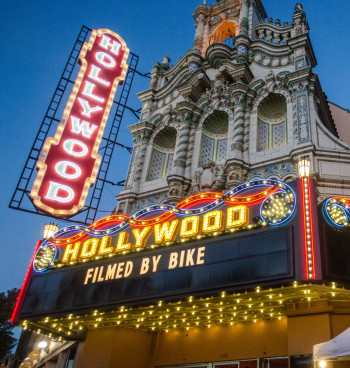 Movie theater marquee showing Filmed by Bike