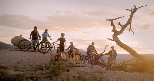 A group of people on bicycles riding up a mountain trail