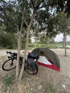 A touring bicycle next to a small tent